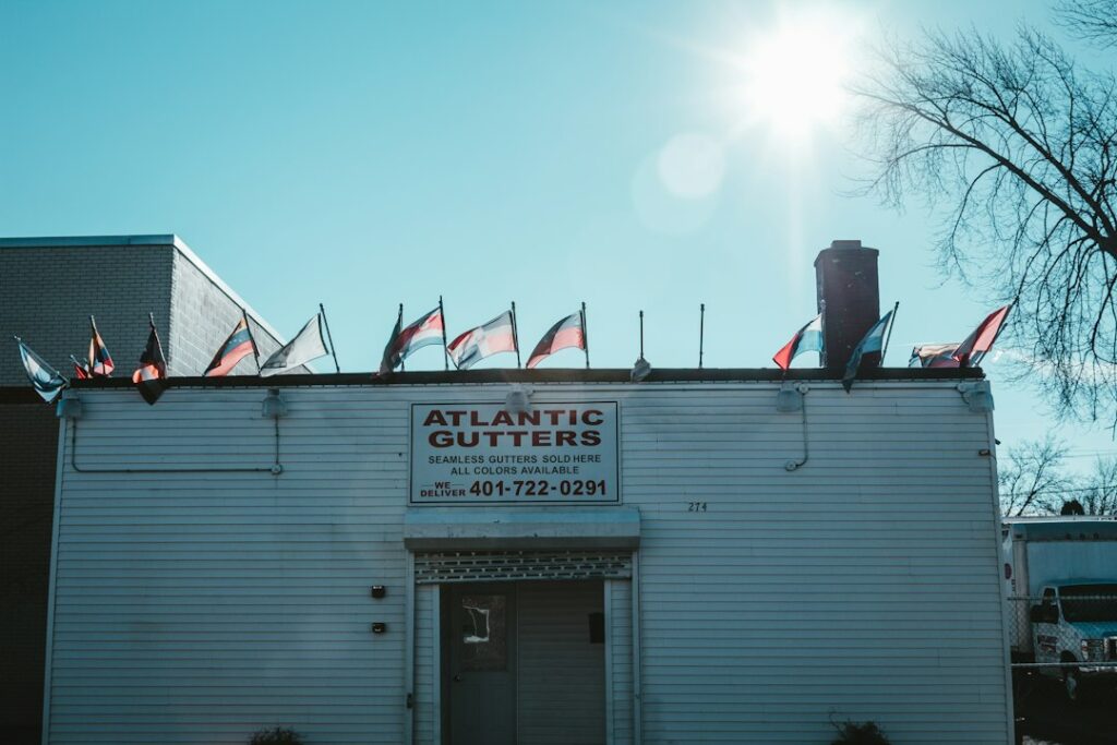 Separated asphalt shingles, metal flashing, clean wood, and cardboard prepared for proper recycling and disposal.