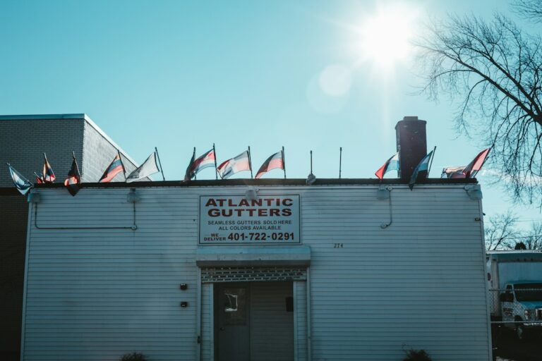 Separated asphalt shingles, metal flashing, clean wood, and cardboard prepared for proper recycling and disposal.